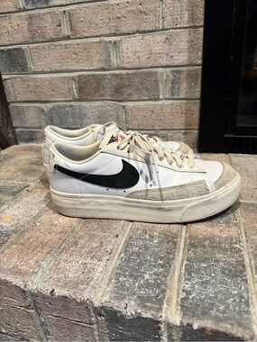 Nike White Low-Top Sneakers with Black Swoosh and Cream Accents